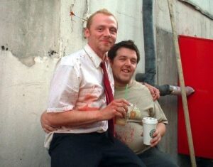 Simon Pegg and Nick Frost hugging each other behind the scenes of Shaun of the Dead