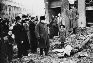 Following German Luftwaffe air raids, Churchill observes streets that have been bombed out.